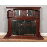 A large carved mahogany over mantle mirror with bevelled edge. H:90cm W: 113cm.