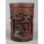 A 19th century carved bamboo lidded brush pot, decorated with figures in landscape scenes. Crack