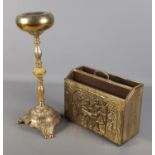 A brass and onyx smokers stand along with a brass bound magazine rack.