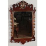 A George III mahogany fret mirror with gilt Hoho bird decoration. 81cm x 48cm. Missing top point