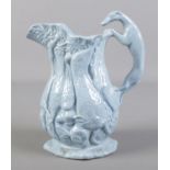 A 19th century Staffordshire jug with greyhound handle and relief moulded game decoration. Crack and