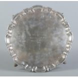 A silver presentation tray raised on four scrolled feet. "With best wishes from the captain and