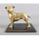 A mounted brass Staffordshire dog on wooden plinth. H: 17cm W: 20cm.