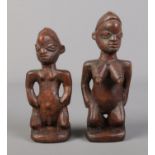A pair of carved African tribal figures, male and female form.