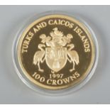 A Turks and Caicos Islands 0.999 silver gilt 1997 100 Crowns coin, commemorating the 50th wedding