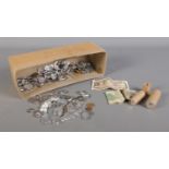 A box of assorted coins, tokens and notes. To include a British Armed Forces One Shilling,
