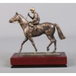 A Cameron Sculptures small bronze model of a jockey and racehorse with gilt detailing.