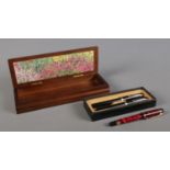 A cased black Sheaffer fountain pen and ball point set, together with red marble effect Waterman