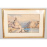 A large gilt framed watercolour, landscape scene depicting figures by a river with buildings and