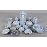 A collection of blue Wedgwood jasperware. Includes clock, vases, trinket boxes etc.