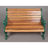 An oak slatted and painted Victorian cast iron garden bench. Bench ends commemorating 'The Royal