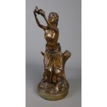 A cast bronze figure of a seated woman with a dove. H: 51.5cm. No signature.