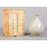 A Korean celadon vase in wooden box. Vase 16cm.