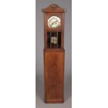 A carved wall clock mounted on longcase clock base.