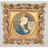 An ornate scrolling gilt framed religious watercolour, depicting The Angel Gabriel before a