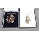 Two silver pendants on chain. Including roundel example set with garnet and central pearl and a