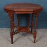 A mahogany octagonal window table, with turned feet supported by square central stretcher. Height: