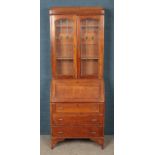 A carved oak stained and lead glazed bureau bookcase. (197cm x 75cm)