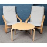 A pair of IKEA oak veneer easy chairs, together with a low egg-shaped coffee table. Chairs in very