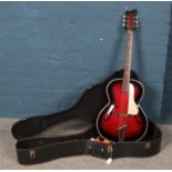A vintage acoustic guitar in carry case. Restrung.