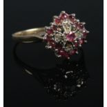 A 9ct gold ruby and diamond cluster ring. Size P 1/2. 2.9g.