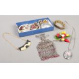 A small box of costume jewellery. Including enamelled locket on chain, bracelets, etc.