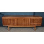 A retro teak sideboard with tapering supports.