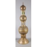 A large Eastern brass bulbous table light, with coloured glass panels. Height: 113cm. In working