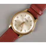 A Nivada Compensamatic wristwatch, with silvered dial and 17 jewel movement on brown leather strap.