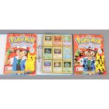 An album Pokemon cards along with two completed Merlin Pokemon sticker books. Including base set,