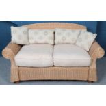 A large wicker 2 seat conservatory settee. Height: 87cm, Width: 157cm, Depth: 93cm.
