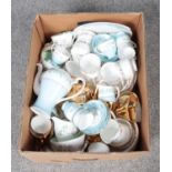 A box of bone china teawares. Includes German gilt example, Paragon Belinda, Rosyln, Royal