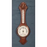 A carved oak Aneroid banjo barometer.