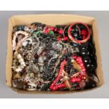 A box of costume jewellery. Including beads, bangles, necklaces, etc.