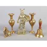 A collection of brass items. Includes cast Viking, dog, pair of vases and a bell.