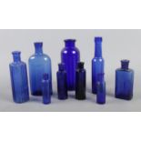 A collection of blue glass chemist bottles, includes 'Not to be Taken' example (9).