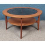 A Schreiber circular coffee table with smoked glass inset top and under tier.