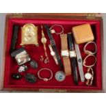 A bijouterie case with contents to include Swiza clock, watches, antique brooches etc.