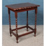 An oak occasional table with bobbin turned supports.