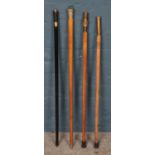 Four assorted walking sticks, to include two topped with WWII 20mm shell cases, another with