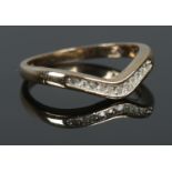 A 9ct Gold and Diamond wishbone ring. Size K. Total weight: 1.64g Small stones missing from both