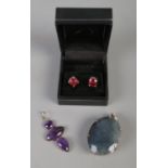 A pair of silver Topaz set stud earrings along with a large sapphire quartz silver pendant and