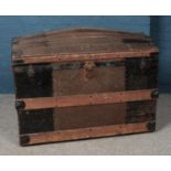 An oak bound dome top trunk, with grape and leaf exterior, brass decoration and liner. Height: 74cm,