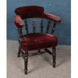 A Victorian tub chair with mahogany frame and velvet upholstery.