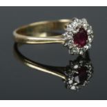 An 18ct Gold Ruby and Diamond cluster ring. Size P, Total weight: 3.29g.