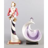 A large Art Deco style Galos ceramic figurine, with purple, red and gilt highlights, raised on