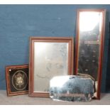 A collection of framed mirrors & wall clock.