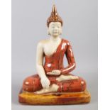 A ceramic and glazed figure of a seated Buddha. H:28cm W:20cm.