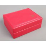 A red leather rectangular Rolex box.