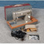 A vintage Pfaff No. 60 sewing machine with accessories.